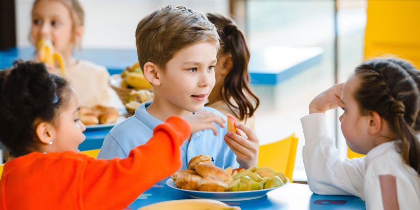 School children being served a hot school meal under the new school food standards.