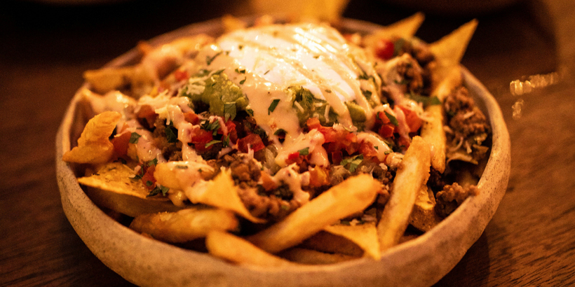 Poutine dish with cheese curds and gravy served on a UK foodservice menu